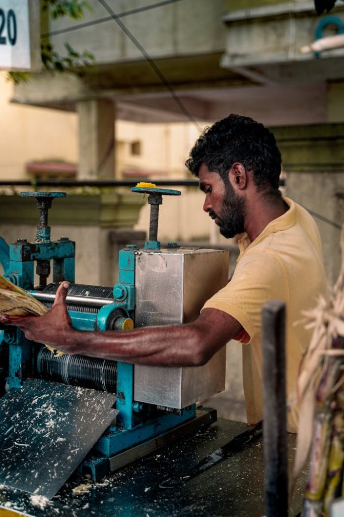 traditional-sugarcane-juice-extraction-in-chennai-28371337 A man operates a sugarcane juice machine on the streets of Chennai, India.